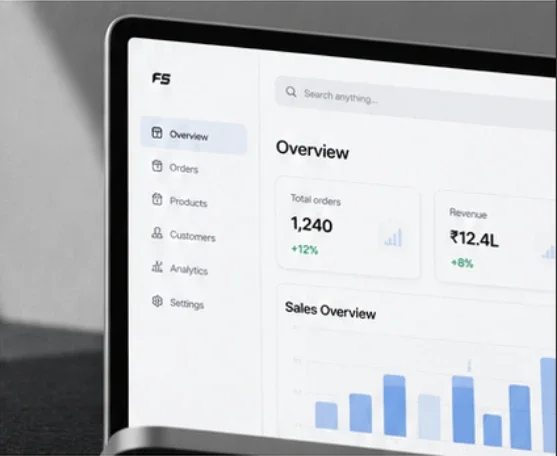 Laptop showing a web app dashboard with orders, revenue and a sales chart